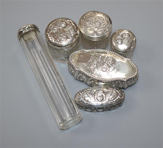 An Edwardian repousse silver trinket box, Birmingham, 1905 and five assorted silver mounted glass toilet jars.